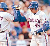 Carlos Delgado greeting Jose at home plate after his homer on 4/24/98