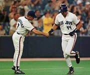 Jose being congratulated on his 12th homer of 1998 (CP Photo)