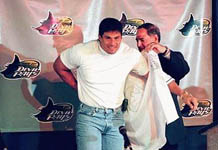 Jose Canseco putting on his new Devil Rays uniform (St. Petersburg Times)