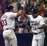 Jose high-fives Randy Winn after his homer on 4/23/99 (AP)