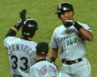 Jose congratulating Fred McGriff after he homered on 9/27/99 (AP)